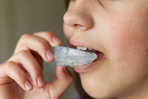 The child uses a mouth guard