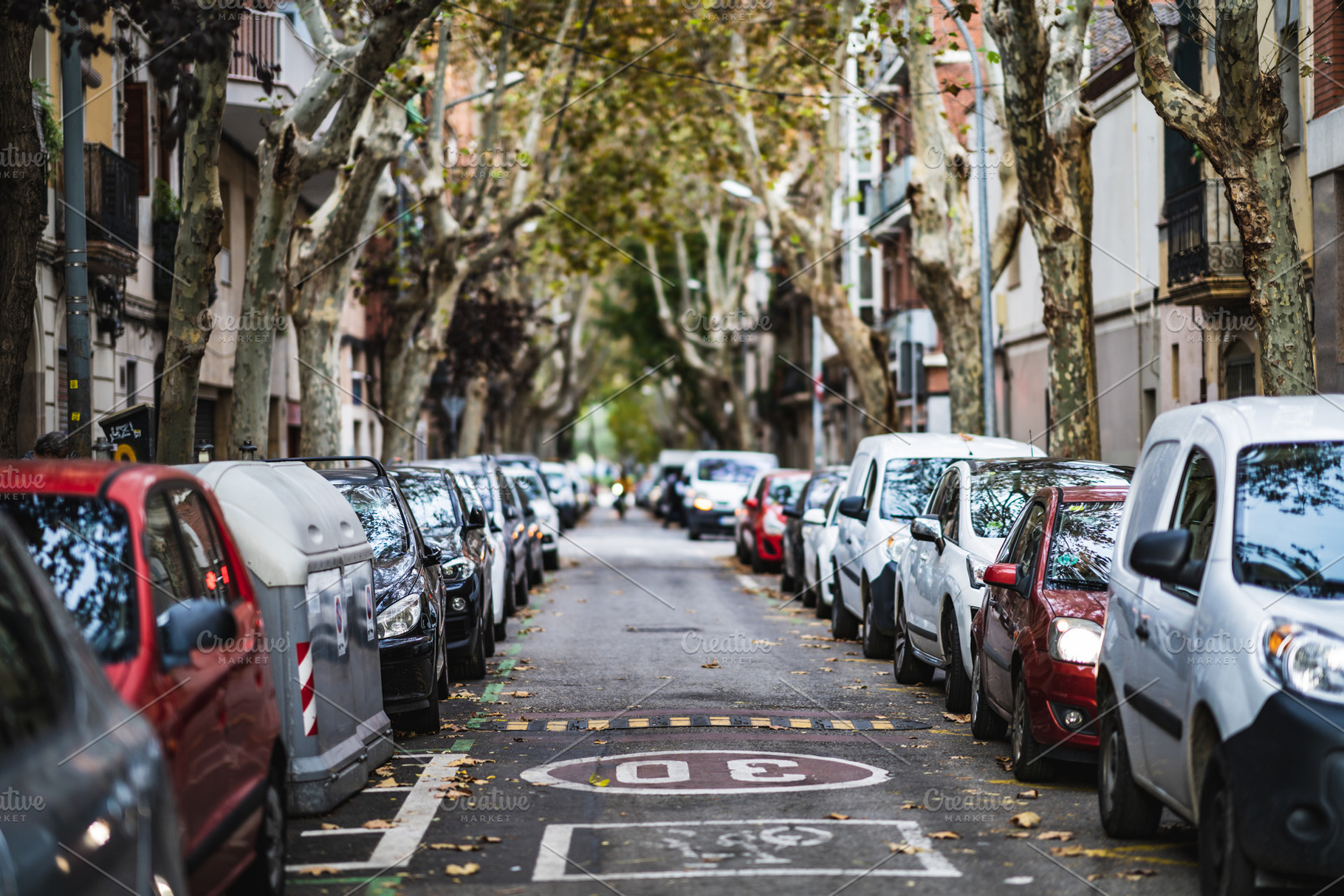 Rows of cars parked along a street, a Transportation Photo by Visual Motiv
