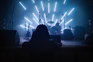 Rock band instruments on stage with radial light beams, a Sports & Recreation Photo by DanFLCreativo