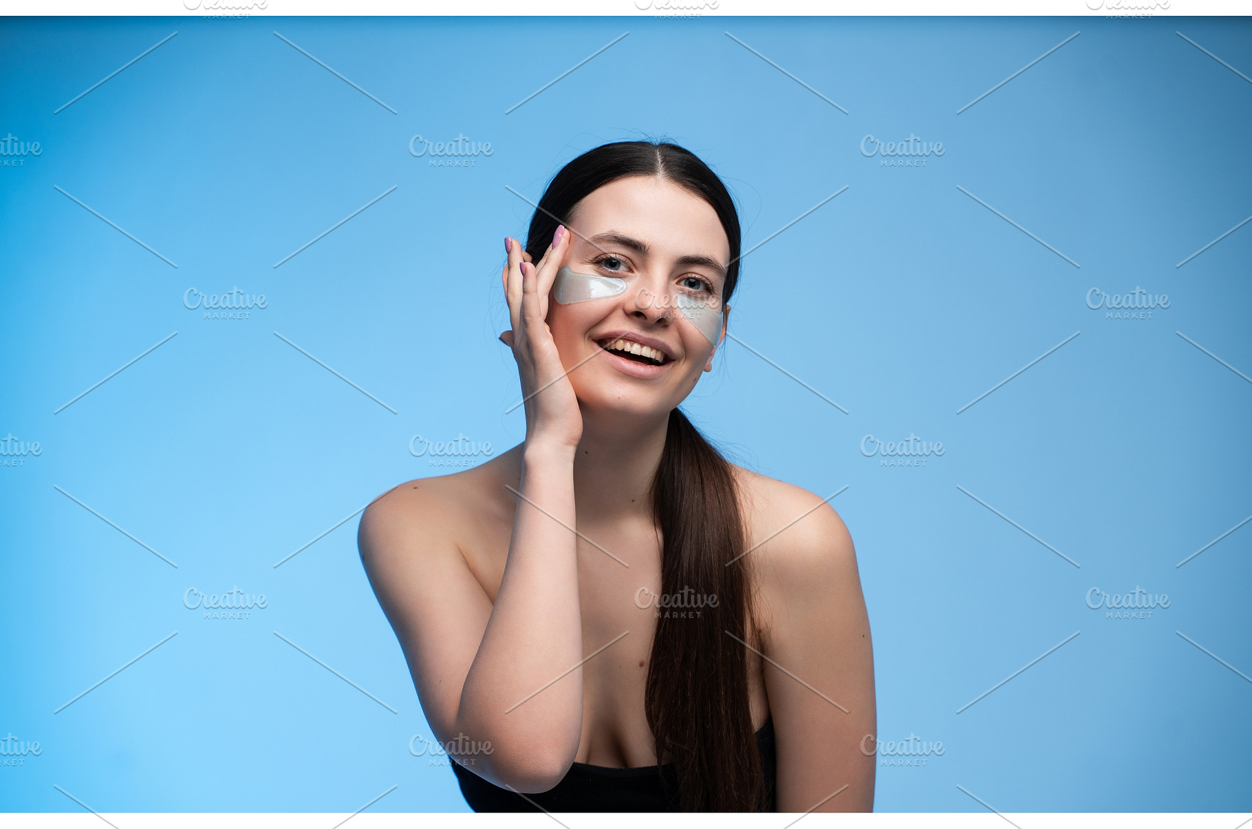 Young woman applying under eye, a Health & Medical Photo by volodymyrshtun13795
