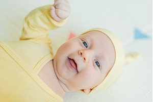 Adorable baby in a yellow hat lying, a Person Photo by Elizaveta Galitskaya