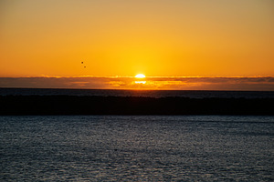 Sunset over the ocean with golden hues and black silhouette, Iceland view, a Nature Photo by AS photostudio