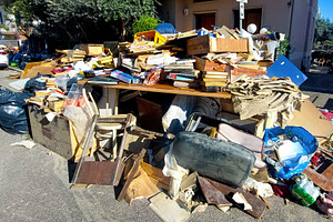 Pile of debris and damaged furniture left on the street after a flood, an Architecture Photo by Antonio Gravante Market