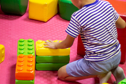 boy playing with building toy blocks