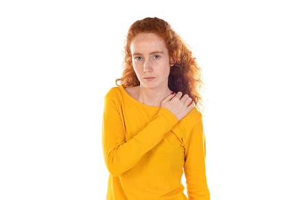 Young redhead woman suffering of backache, touching her shoulder, a Person Photo by José Manuel Gelpi