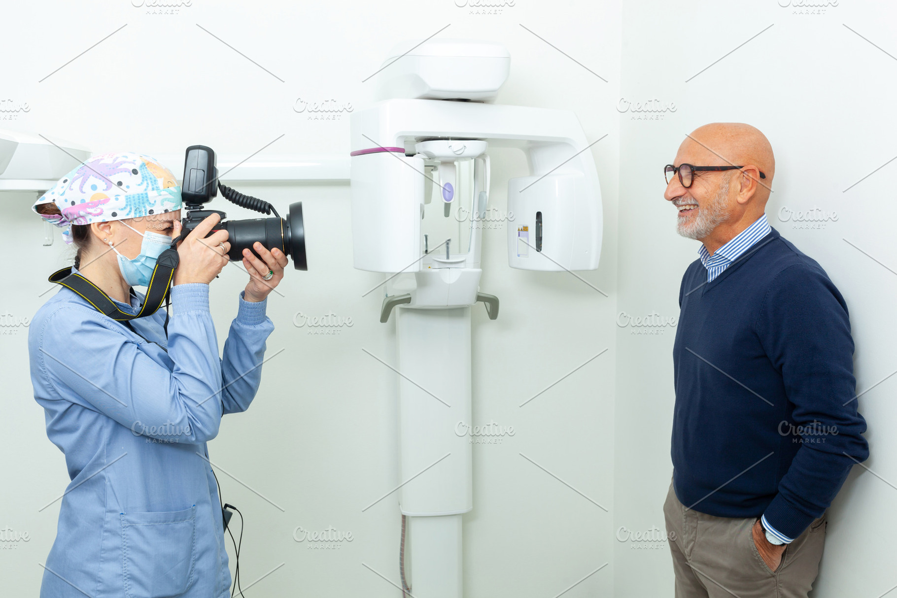 Dentist taking pictures of senior patient with professional came, a Photo by Antonio Gravante Market