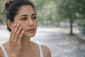 Woman outdoors care for skin under s, a Photo by Dvoevnore photos
