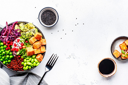 Healthy vegan food. Buddha bowl with quinoa, fried tofu, avocado, a Food & Drink Photo by 5PH