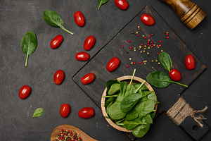 Fresh spinach leaves, cherry tomatoes, and mixed peppercorns on, a Food & Drink Photo by ndanko