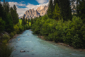 River and high mountains at sunset, a Nature Photo by Alpine Dreams