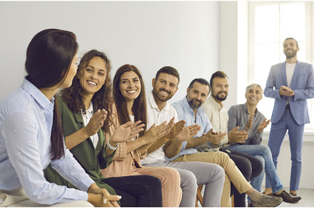 Smiling men and women sitting in a, a Person Photo by StudioRomantic