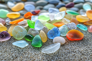 Colorful sea glass pieces scattered, a Photo by Iftikhar Alam