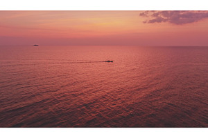 Fishing boat sailing on calm sea at, a Nature Photo by Goinyk