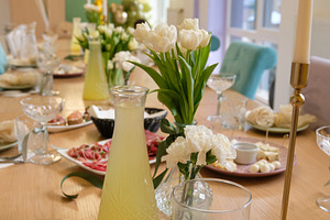Festive birthday table setting with white tulips, golden candle holder and lemo, a Food & Drink Photo by Rohan Photography