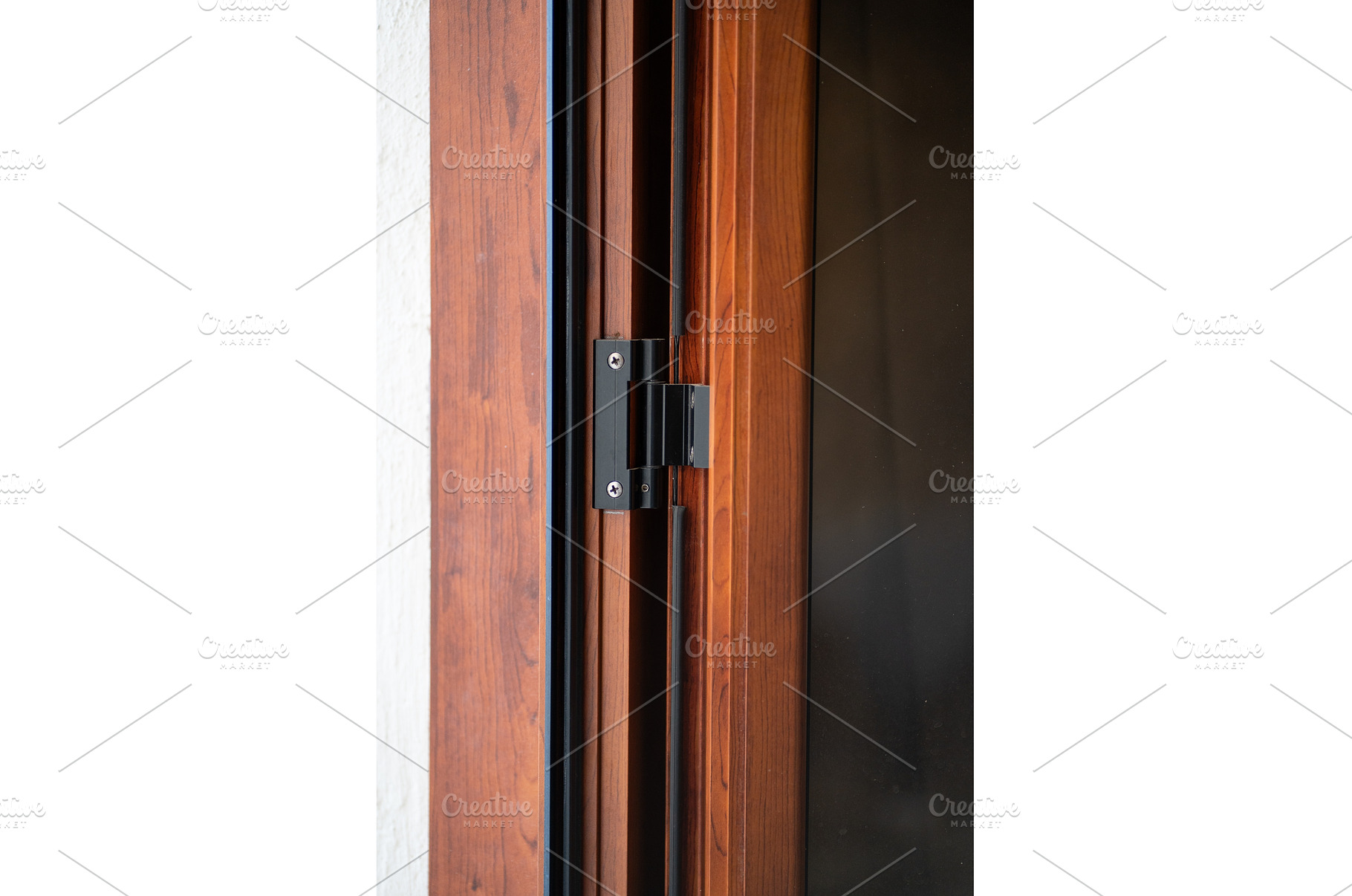Black metal door hinge attaching a, an Architecture Photo by volodymyrshtun13795