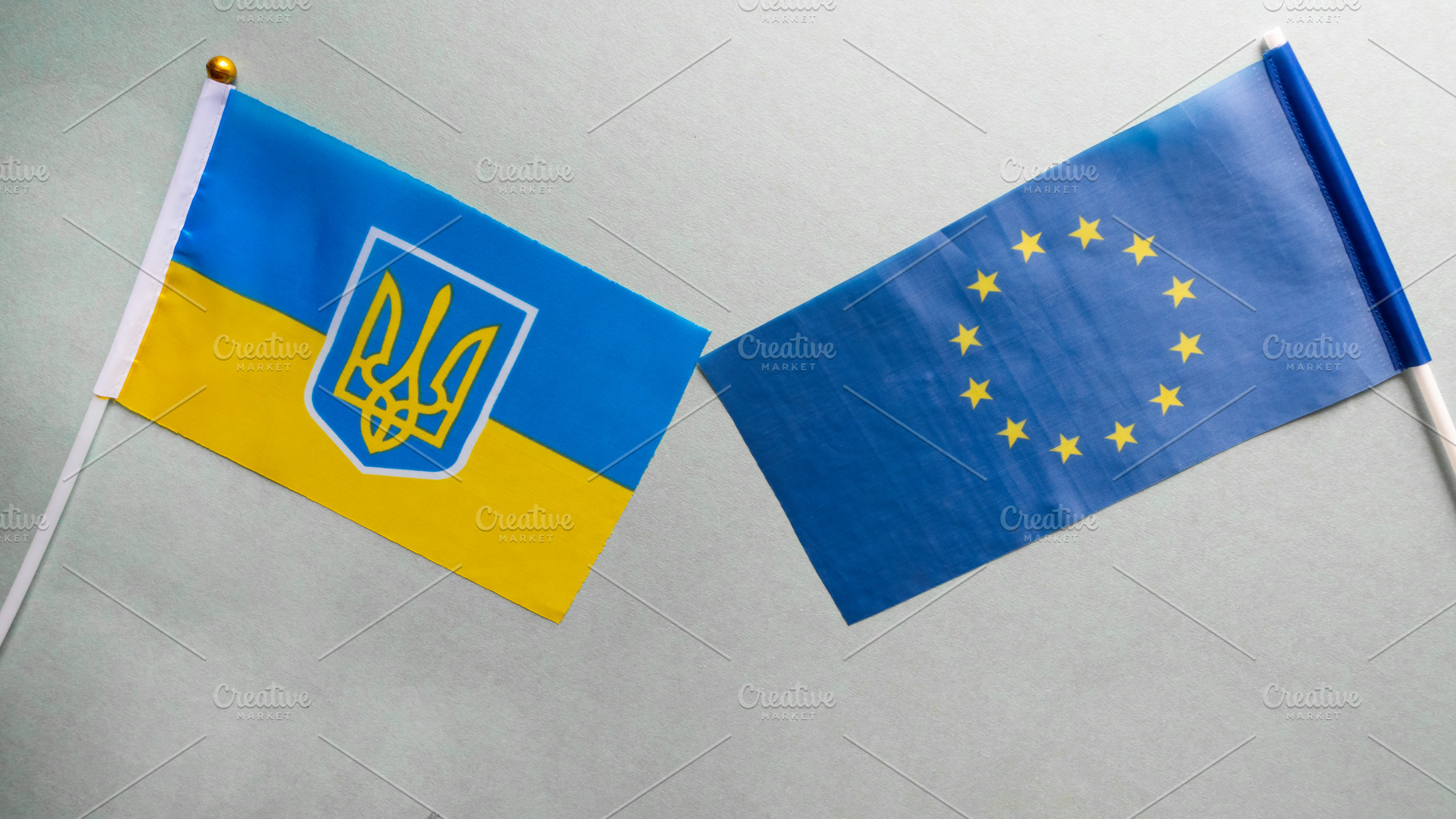 European union and Ukraine two folded silk flags together, a Background Photo by OleksandrRybitskyi