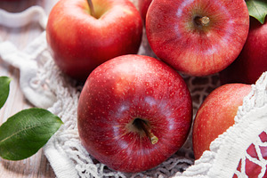Fresh red apples resting in reusable shopping bag promoting sust, a Food & Drink Photo by Olena Rudo
