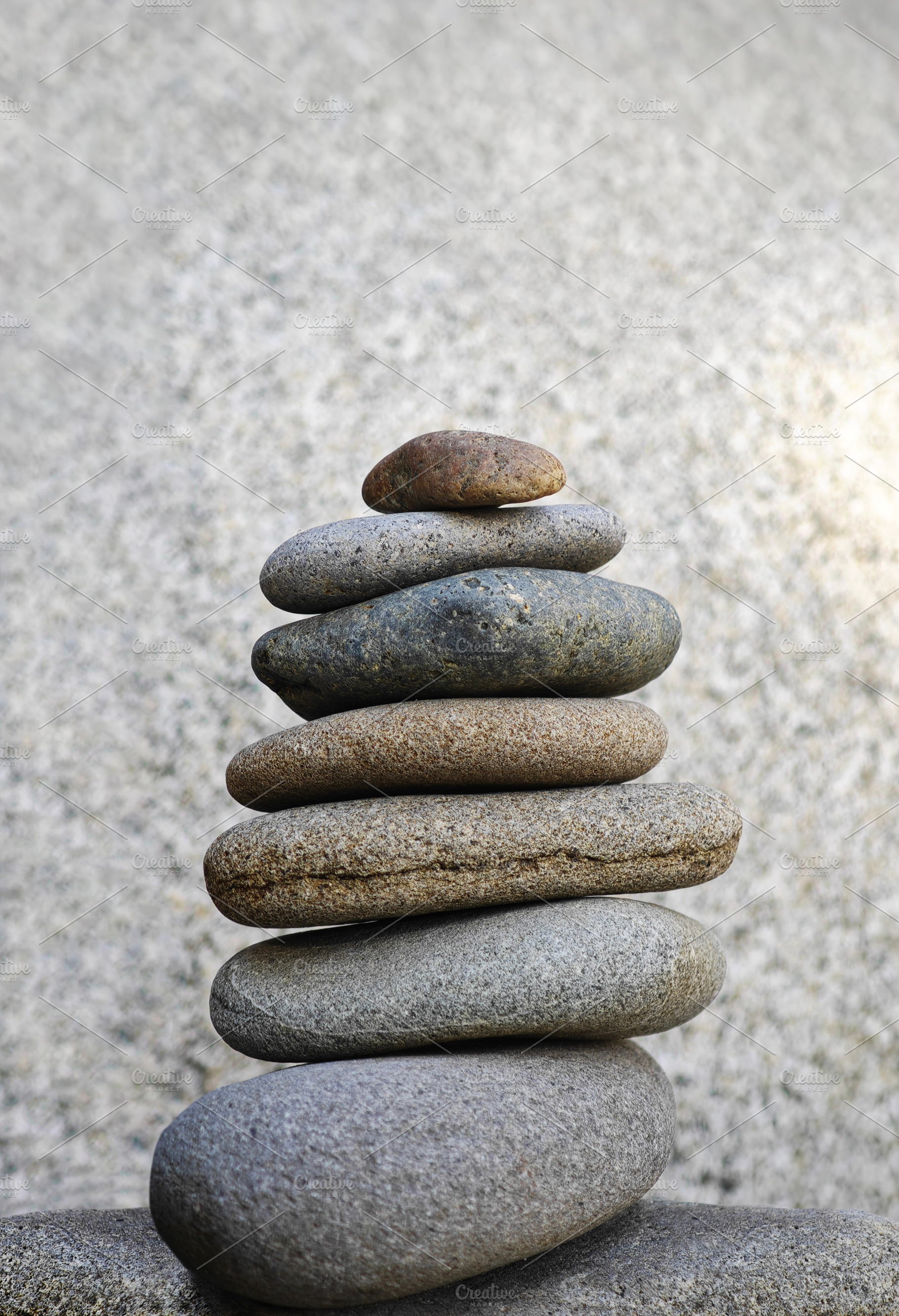 Stacked stones in perfect balance, symbolizing meditation, a Photo by salmon.black