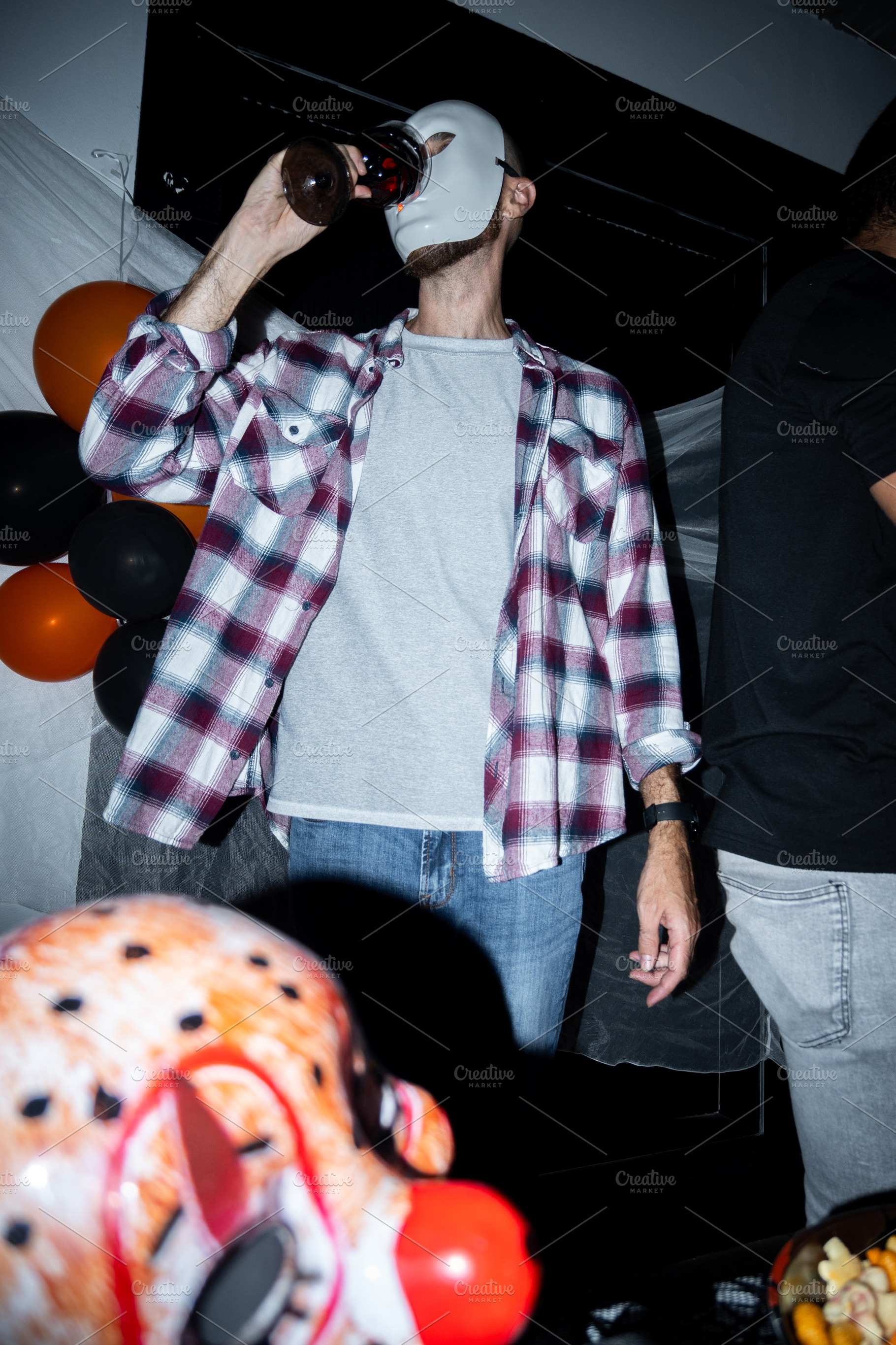 Masked man enjoying a drink at Halloween party, a Holiday Photo by etorres69