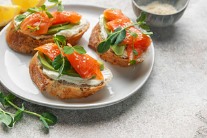 Salmon avocado toasts with microgreens for healthy breakfast, a Food & Drink Photo by Olena Rudo