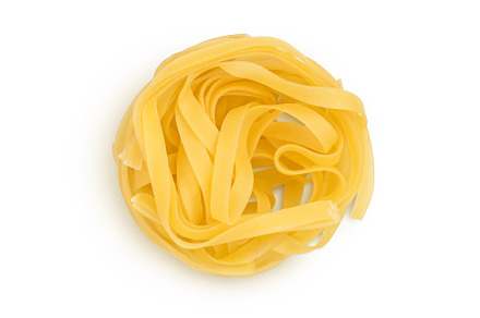 Raw tagliatelle pasta isolated on, a Food & Drink Photo by NataPhoto