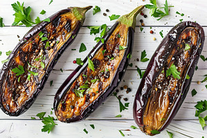 Baked eggplants on white wooden table, a Food & Drink Photo by AlyaAnd