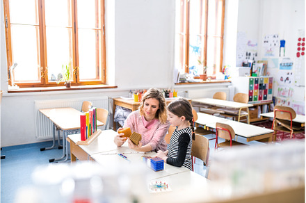 Hardworking teacher learning with, a School & Education Photo by HalfPoint