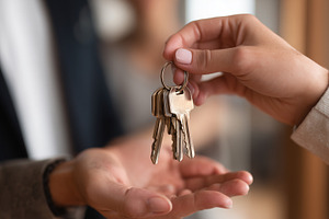 Close up of person handing keys, a Business Photo by MistyDay