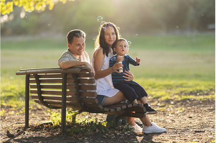 Cute white family sitting on a bench, a Person Photo by Barcelona_dreams