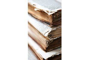Close up of a stack of worn antique, a Background Photo by Lermont51