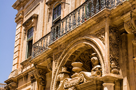 Facade of a building, door and balconies with worked structure i, an Architecture Photo by Angelo D'Amico Photograph
