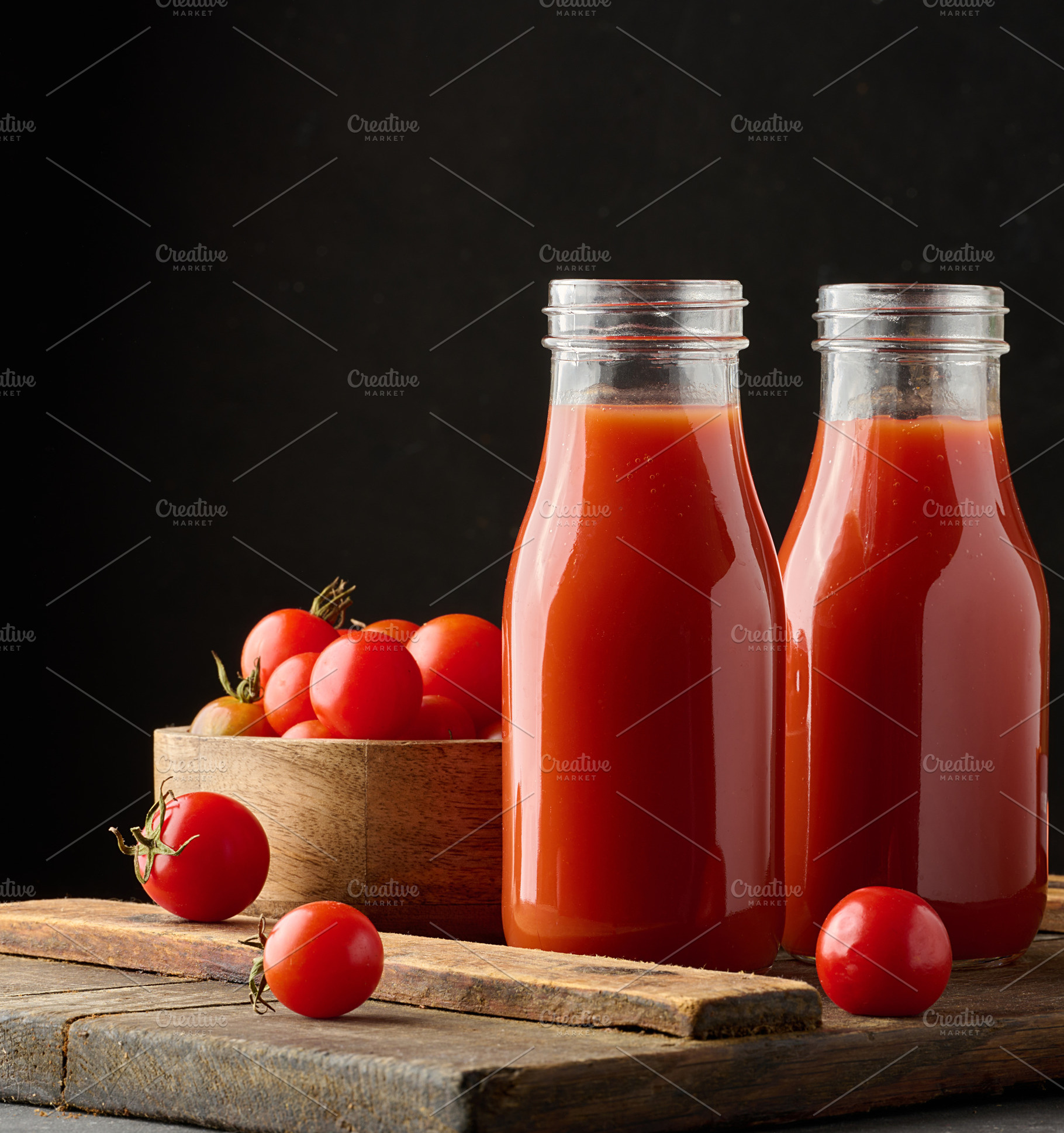 Full glass bottle with tomato juice on dark background, a Food & Drink Photo by ndanko