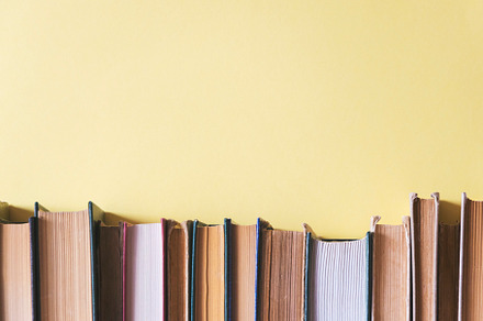 Old books on a yellow background, a School & Education Photo by Ti-Di