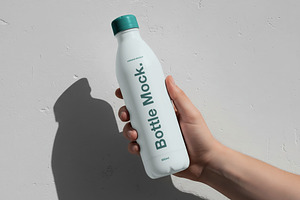 Hand Holding Water Bottle Mockup, a Cups & Container Mockup by Templeste