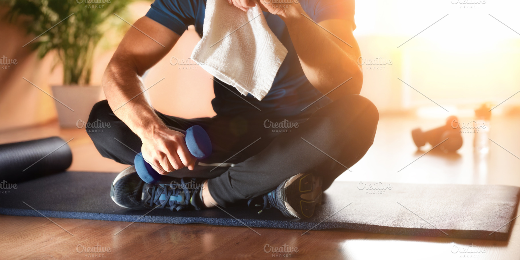 Man sitting on a mat doing sports at home, a Sports & Recreation Photo by Davizro's Market
