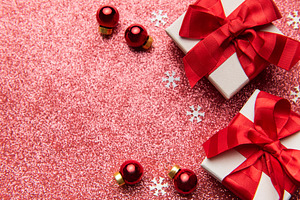 Christmas gifts decorating a red glitter background, a Holiday Photo by Olena Rudo