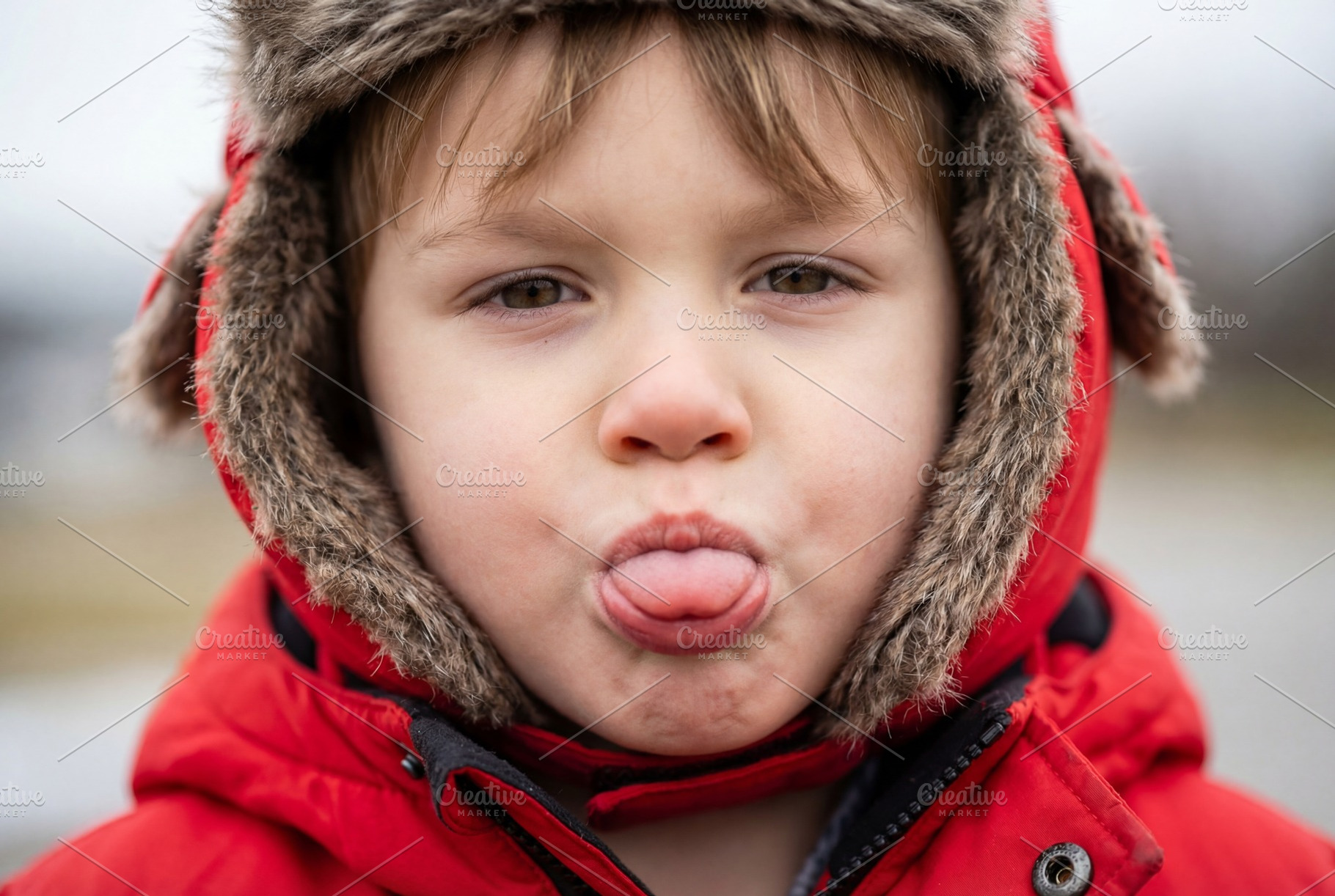 Close up portrait of playful toddler, a Person Photo by Virgo Studio