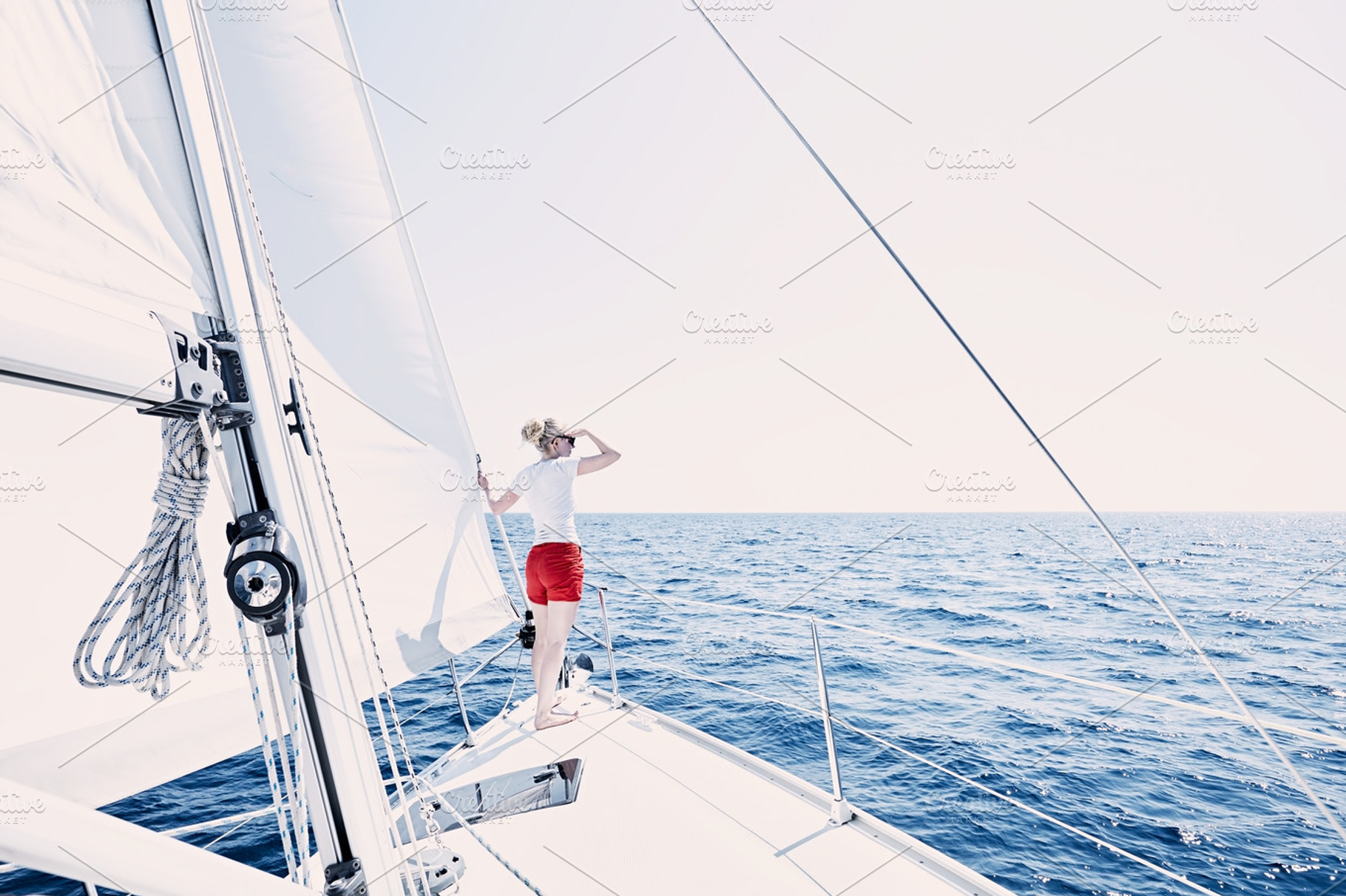 Girl on sailboat featuring active, adventure, and boating, a Holiday Photo by Sergey Furtaev