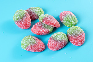 Strawberry candies on blue background, a Food & Drink Photo by etorres69