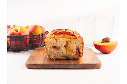 Peach cake loaf on wooden cutting