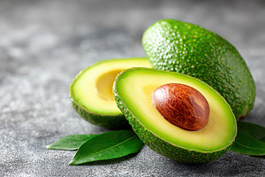 Bright green avocado halves with shiny texture and smooth flesh on a gray backg, a Food & Drink Photo by AlyaAnd
