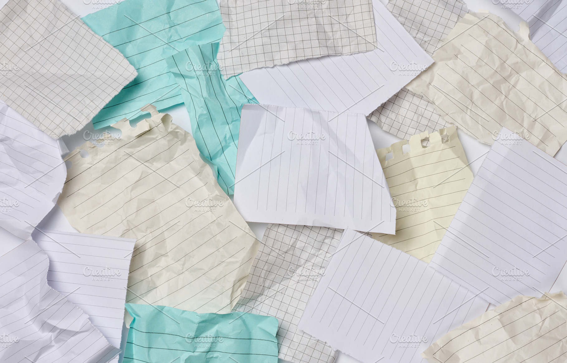 Messy pile of crumpled and torn multicolored grid and lined pape, a Business Photo by ndanko