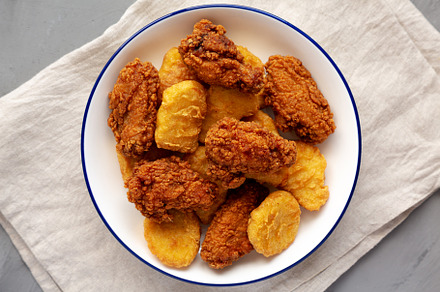 Homemade Chicken Nuggets and Chicken Wings on a Plate, top view., a Food & Drink Photo by LiudmylaChuhunova