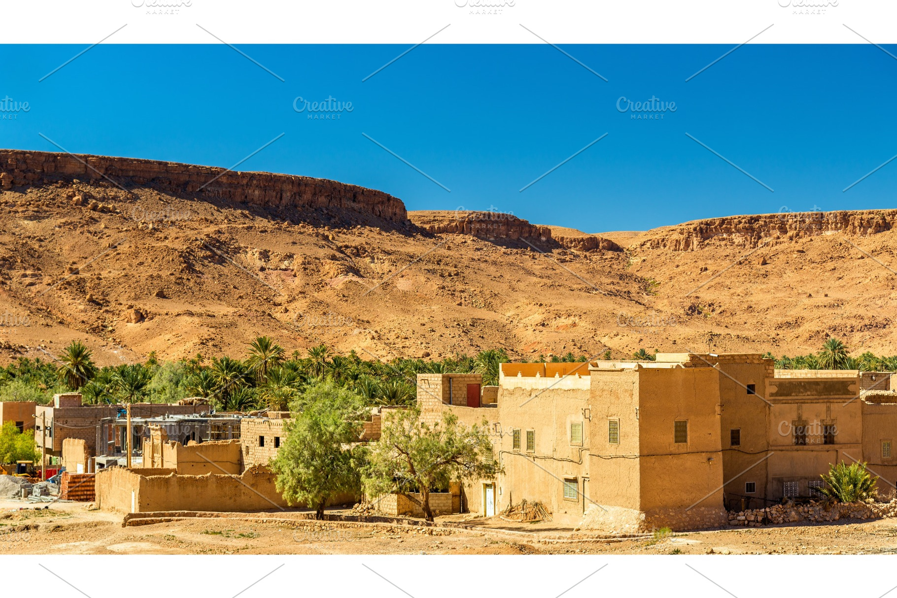 A village with traditional kasbah houses in ziz valley morocco featuring, an Architecture Photo by Leonid Andronov