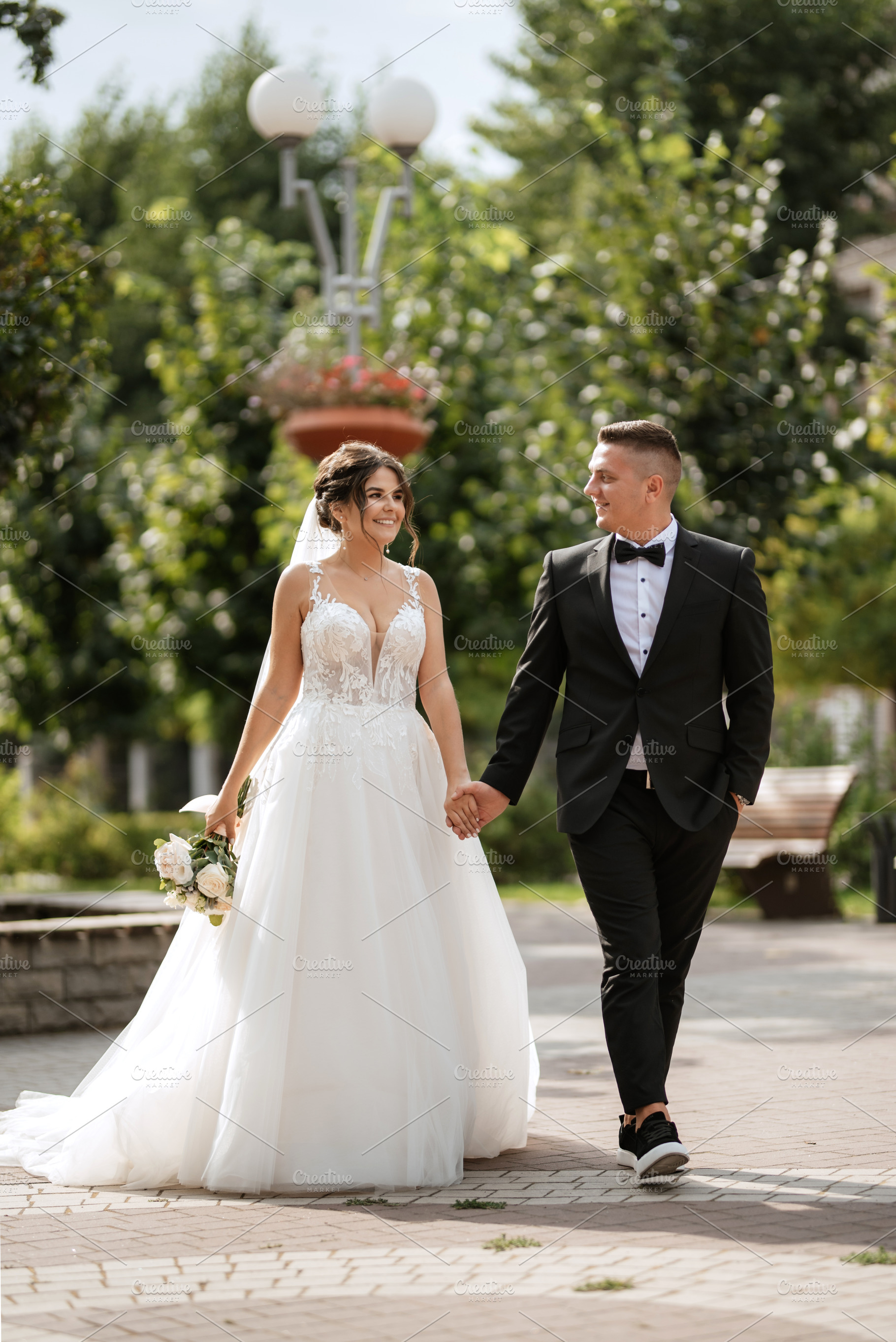 the groom in a brown suit and the bride in a white dress, a Person Photo by Weddings, People, Travel
