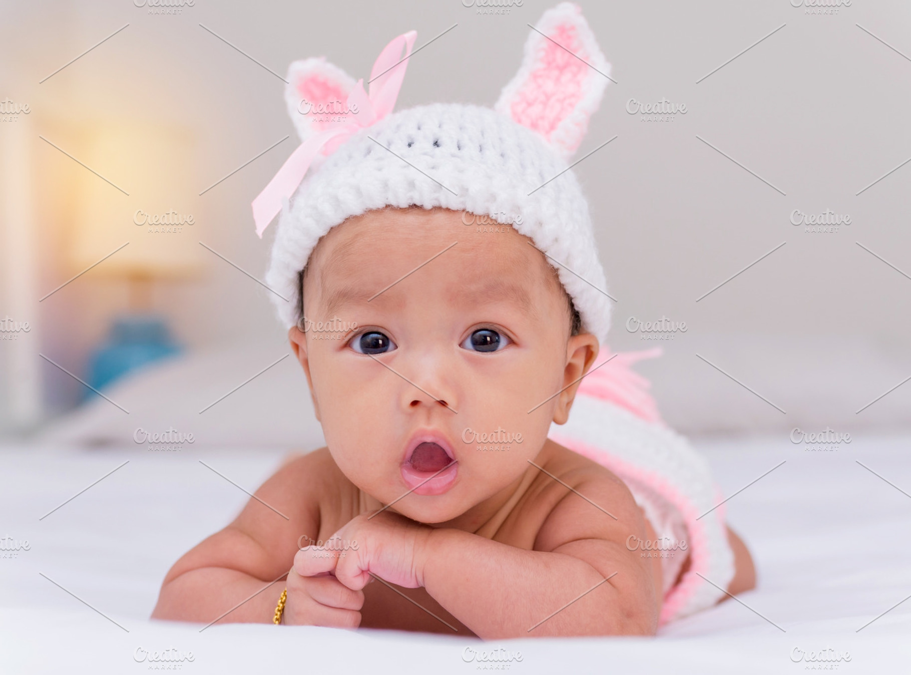 Portrait of cute baby girl on bed featuring cute, girl, and newborn, a Person Photo by Casanowe-studio