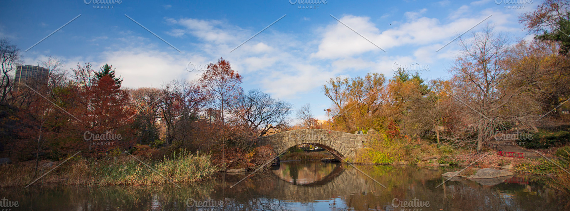 Autumn Gapstow Bridge under blue cloudy sky in Central Park, wid, a Photo by Pictures for you!!!!!!!!!