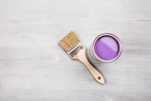 Paintbrush and open can of purple
