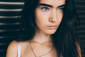 Portrait calm brunette girl wearing white top