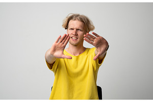 Young man showing a stop gesture, a Person Photo by volodymyrshtun13795